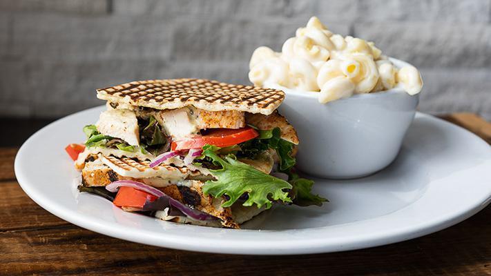 Chicken Breast Panini · Seasoned grilled chicken, basil pesto aioli, field greens, Mozzarella, red onions, and tomatoes on flatbread. Served with your choice of side.