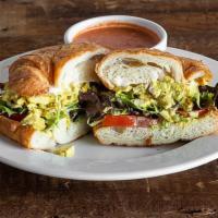 Curry Chicken Salad Sandwich · Our signature curry chicken salad topped with field greens and tomatoes on a butter croissan...