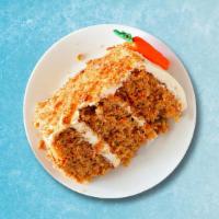Carrot Cake Classico · Modern carrot cake with white cream cheese frosting with pecan nuts and premium almonds.