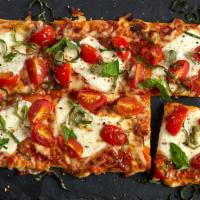 Margherita Flat · Mamma Mia! Our stonefire flatbread topped with fresh mozzarella cheese, blistered cherry tom...