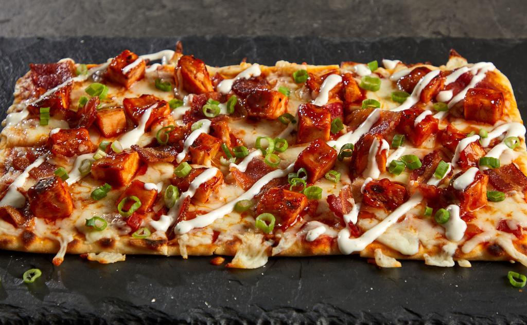 Bbq Chicken & Bacon Flat · BBQ Party! Our stonefire flatbread topped with Sweet Baby Ray BBQ chicken, crispy bacon, and shredded mozzarella with ranch dressing drizzle garnished with fresh scallions.