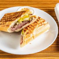 Cuban Sandwich · Slow roasted pork, ham, swiss cheese, mustard and pickles. Grilled pressed to Cuban  perfect...