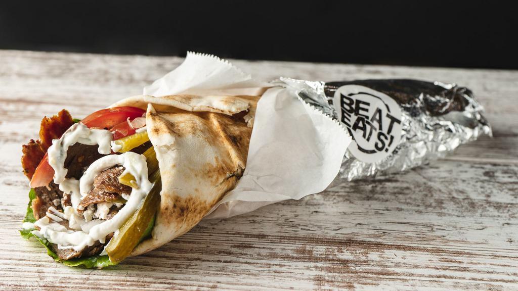 Gyro Sandwich · Greek pita bread topped with lamb meat, taziki sauce, cucumber pickles, onions, tomatoes and  lettuce.