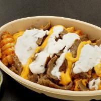 Gangster Fries · A bed of fries topped with nacho cheese, gyro meat, and taziki sauce.