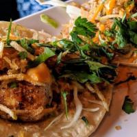 Mahi Mahi Tacos · Three mahi mahi tacos with cilantro lime aioli, cabbage, crispy potato strips, cilantro, and...