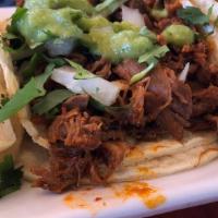Tacos Al Pastor · Tacos made with pork marinated in red guajillo sauce, topped with onion, cilantro and pineap...