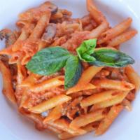 Rigatoni Boscaiola · Rigatoni pasta tossed with sauteéd mushrooms, tomato sauce, basil, parmigano, and a touch of...