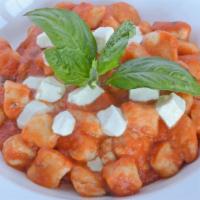 Gnocchi Di Patate Sorrentina · Home-made potato dumplings, tomato sauce, diced mozzarella, basil.