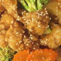 Sesame Chicken · Crispy battered chicken with carrot, broccoli and pineapple in tangy sweet and sour sauce sp...