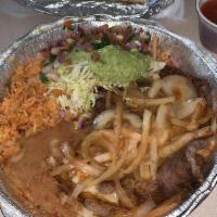 Lunch Carne Asada · Tender ribeye seasoned and covered with sauteed onions, served with guacamole salad, mexican...