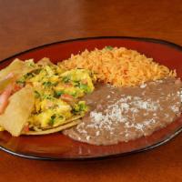 Huevos A La Mexicana · Scrambled eggs with chopped tomato, onion, and jalapeno pepper. Served with rice, beans, and...