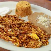 Huevos Con Chorizo · Scrambled eggs with Mexican sausage. Served with rice, beans, and tortillas.