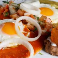 Huevos Divorciados · Fried eggs covered with red and green sauce. Served with rice, beans, and tortillas.