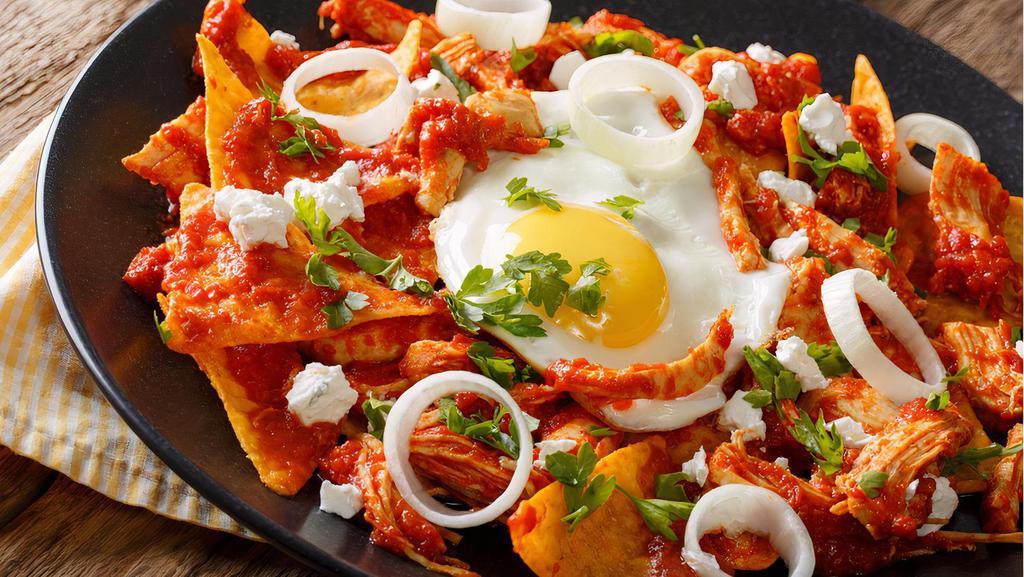 Chilaquiles Con Huevos · Fried tortilla chips with red or green sauce on top. Served with eggs, cheese, and sour cream. Served with rice, beans, and tortillas.