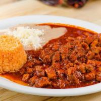 Guisado De Puerco · Fried pork with your choice of red or green sauce served with rice, beans, and housemade tor...