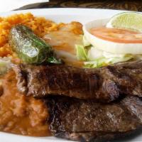 Carne Asada And Chile Relleno · Tender skirt steak and a chile relleno. Served with frijoles charros and housemade tortillas.