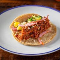 Al Pastor Tacos · 3 braised pork tacos with pineapple, cotija cheese, pickled red onion and cilantro. served w...
