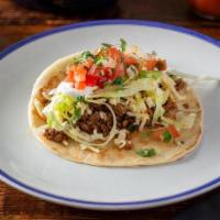 Ground Beef Tacos · 3 tacos served with shredded cheese, lettuce, pico de gallo, sour cream. Comes with rice and...