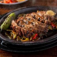 Steak Fajitas · hand trimmed, 3 chile marinade and served with rice and beans, guacamole, roasted onions and...