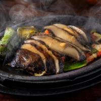 Portabello Fajitas · served with rice and beans, guacamole, roasted onions and peppers, flour tortillas
