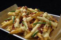 Pile Of Fries · Natural-cut fries, gouda cheese sauce, bacon, chives