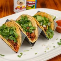 Tacos Al Carbon · Three tacos filled with steak, chicken and shrimp cooked with onions and our special sauce. ...