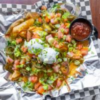 Nachos · Veggie refried beans, tomatoes, onions, jalapenos, sour cream, a blend of cheese and salsa.