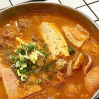Budae Jjigae (Army Stew) · Spicy stew with kimchi, bacon, spam, sausage, ramyun noodles, tofu, rice cakes and green onion