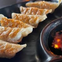 Gyoza · Pan-fried Japanese pork dumplings served with gyoza sauce.