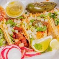 Tacos Callejeros / Street Tacos · De asada, pastor, carnitas o pollo o chorizo. Lengua por un precio adicional. / Steak, marin...