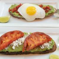 Ann Avocado Toast · Crispy organic multi-grain bread topped with creamy avocado, goat cheese, roasted tomatoes, ...