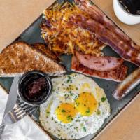Breakfast Sampler · Two strips of ham, two pieces of bacon and a pork sausage link, with two eggs. Served with h...