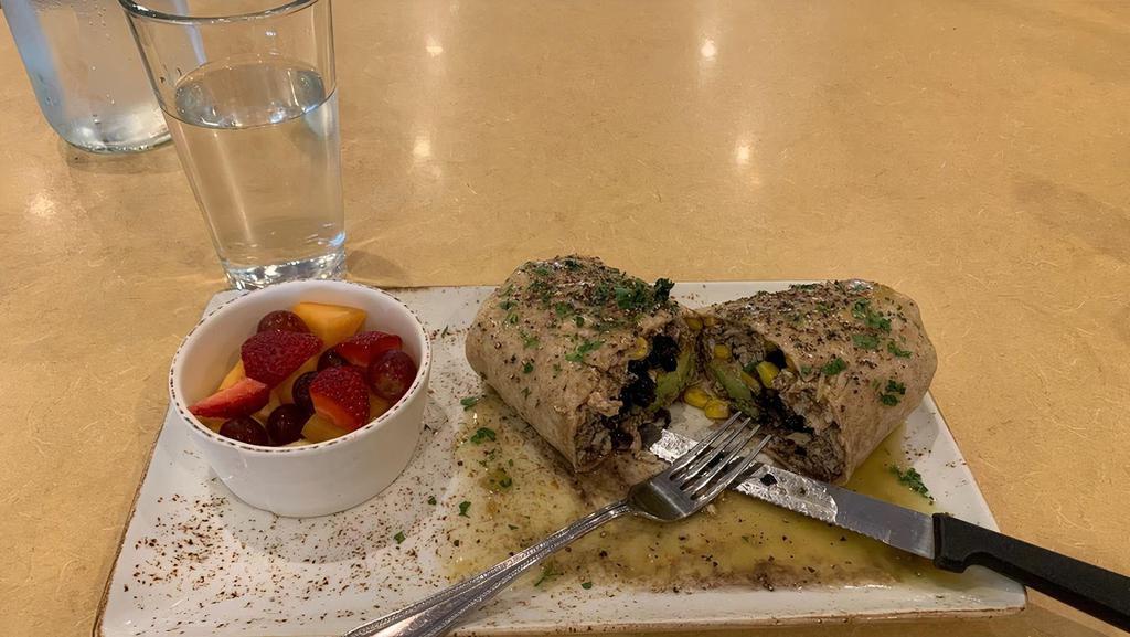 The Healthy Burrito · Egg whites, chicken, beef chorizo, avocado, corn, and black beans wrapped in a whole wheat tortilla topped with green chili sauce and served with a cup of fruit.