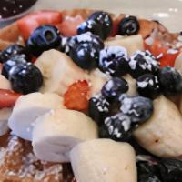 Fruity Waffle · Topped with blueberries, strawberries, bananas and cinnamon powdered sugar and served with a...