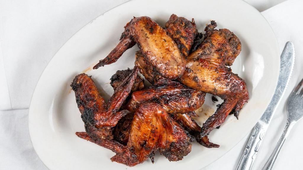 Jerk Wings (6 - Whole) Plus 3 Sides · Chicago's #1 jerk wings, marinated with Caribbean spices and chef's distinct seasonings, then slow cooked. Served with spicy jerk sauce (optional)!.