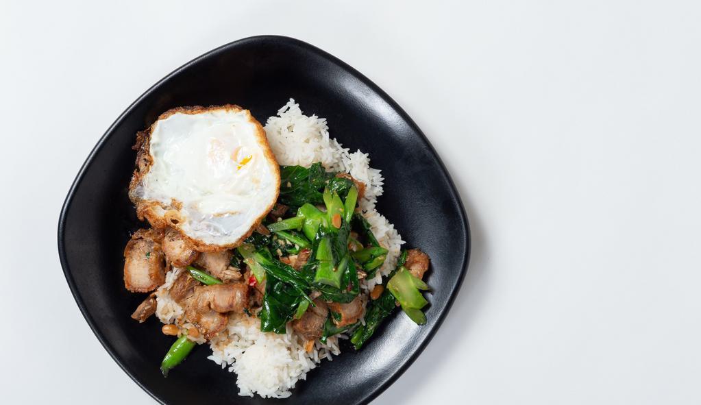 Thai Crispy Pork Stir-Fried With Kai-Lan · Stir-fried crispy pork with Chinese broccoli, chili, onion, and bell peppers served with white rice and topped with fried egg.