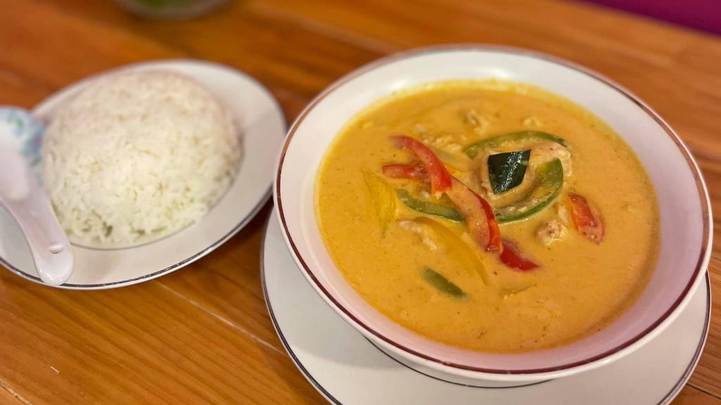 Panang Chicken Curry · Mild spice, creamy coconut flavor curry with sliced red and green pepper, napa, and onion, served with steamed jasmine rice.
