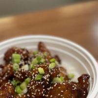 Orange Sesame Chicken · Crispy chicken in sweet and sour sauce sprinkled with sesame seed and green onion on top ser...