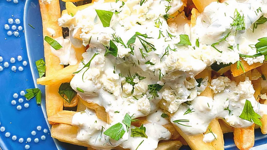 Greek French Fries · Seasoned French fries topped with our house sauce, Feta cheese, olive oil, Greek herbs and spices.