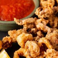 Calamari · Tender calamari mixed, lightly breaded and served with side of our house dressing
