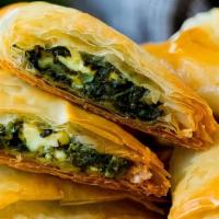 Spanakopita  · Chopped spinach, diced onions and feta cheese, served in a flaky puffed shell with house dre...