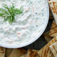 Tzatziki (Large) · Yogurt dip made with grated cucumbers and garlic, served with 2 pita bread.