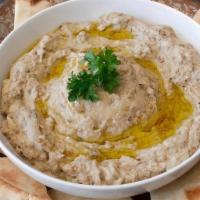 Baba Ghanoush (Large) · Roasted eggplant blended with tahini, garlic and lemon topped with olive oil and served with...