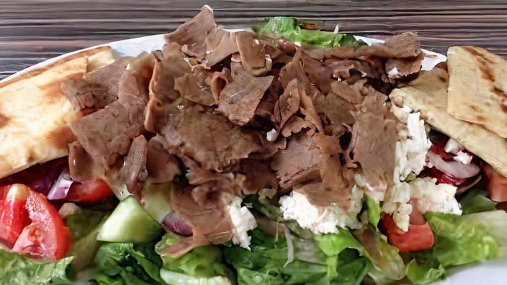 Gyro Salad · Our house salad topped with gyro meat, Our house sauce and pita bread