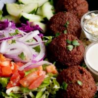 Falafel Greek Salad (3-6 Pieces) · Our house salad topped with falafel, Our signature hummus, our house sauce and a pita bread ...