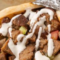 Gyro · A delicious blend of beef and lamb roasted with spices, Thinly sliced and served on warm pit...