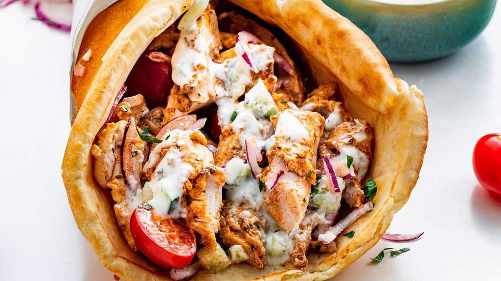 Chicken Gyro · Marinated grilled chicken tenderloin, Served on warm pita bread with lettuce, Tomatoes, Onions, Banana peppers and our house dressing.