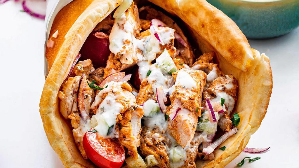 Spicy Chicken Gyro · Marinated grilled chicken tenderloin, mixed with a hot sauce, Served on warm pita bread with lettuce, Tomatoes, Onions, Banana peppers and our house dressing.