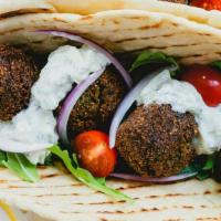 Falafel Sandwich · Falafel patties rolled into pita bread with a spread of hummus topped with tomatoes, Lettuce...