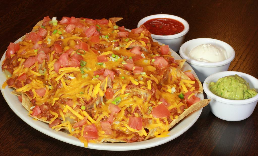 Nachos · Chili, Taco Meat, Tomato, Cheese on a bed of Tortilla Chips 
*Includes Side Sour Cream and Salsa